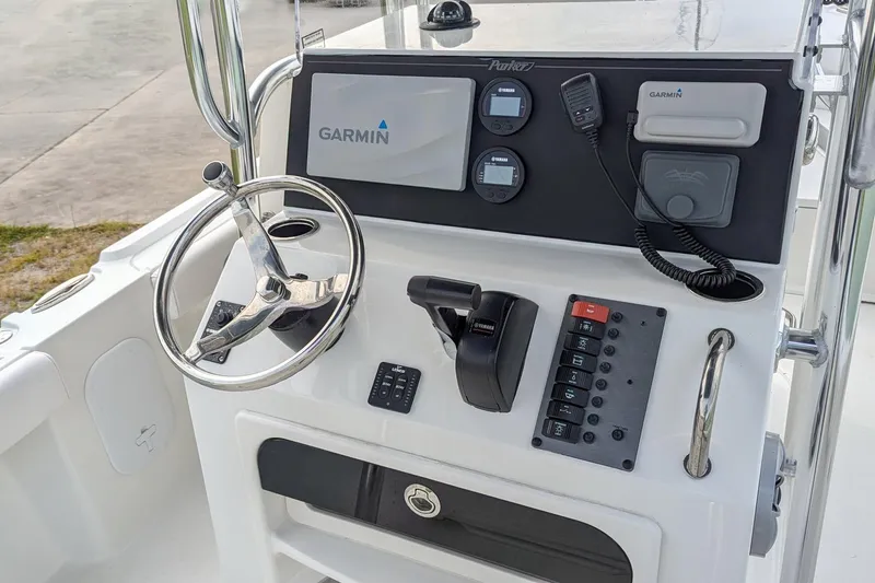 Slide: The Image of 2026 Parker 210 Coastal boat dashboard with Garmin navigation and control panel. - 6