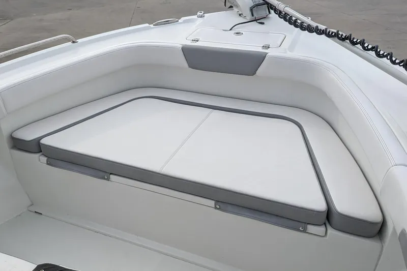 Slide: The Image of 2026 Parker 210 Coastal boat interior with cushioned seating area. - 9