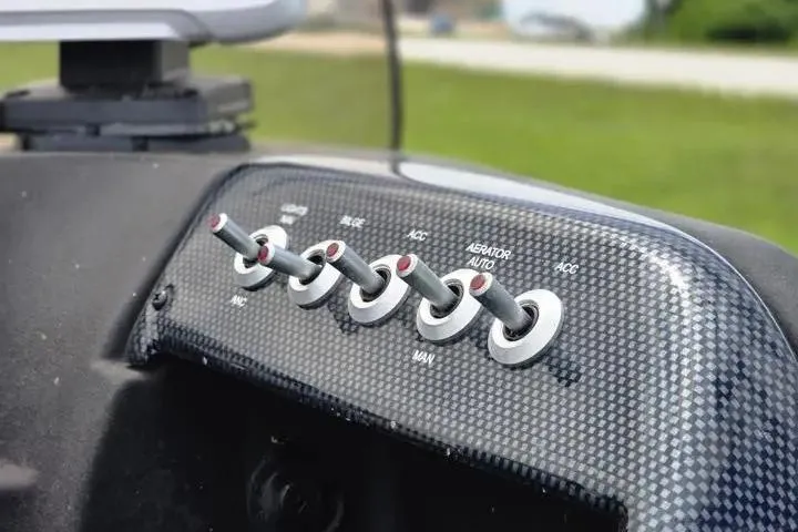 Slide: The Image of Control panel of 2021 Lowe Fishing Machine 1775SC with toggle switches. - 35