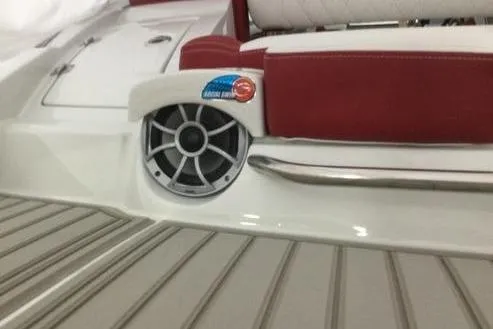 Slide: The Image of 2024 Crownline Eclipse E235 boat interior with red seating and speaker detail. - 10