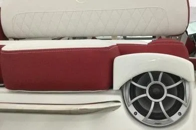 Slide: The Image of 2024 Crownline Eclipse E235 boat seat with red and white upholstery and built-in speaker. - 11