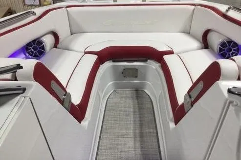 Slide: The Image of 2024 Crownline Eclipse E235 boat interior with red and white seating and built-in speakers. - 3