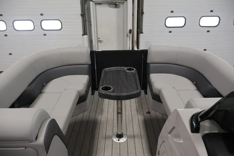 Slide: The Image of 2026 Bentley Pontoons 223 ELITE SWINGBACK DUAL CAPTAIN interior with sleek seating and table. - 30