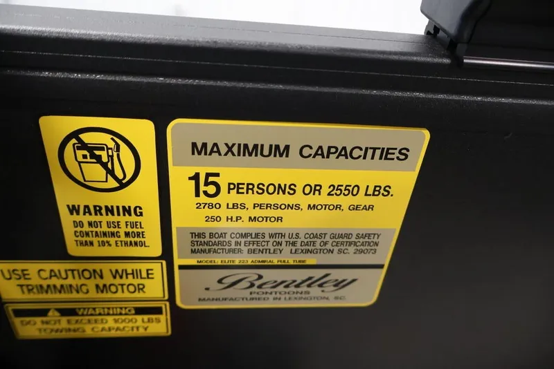 Slide: The Image of 2026 Bentley Pontoons 223 Elite Swingback capacity label, 15 persons or 2550 lbs, safety warnings. - 19