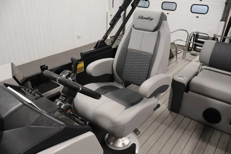 Slide: The Image of 2026 Bentley Pontoons 223 Elite Swingback Dual Captain seat, luxurious design, gray upholstery. - 31