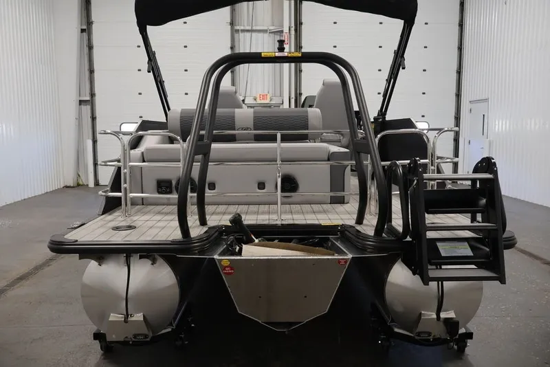 Slide: The Image of 2026 Bentley Pontoons 223 Elite Swingback Dual Captain, rear view in a spacious indoor setting. - 21