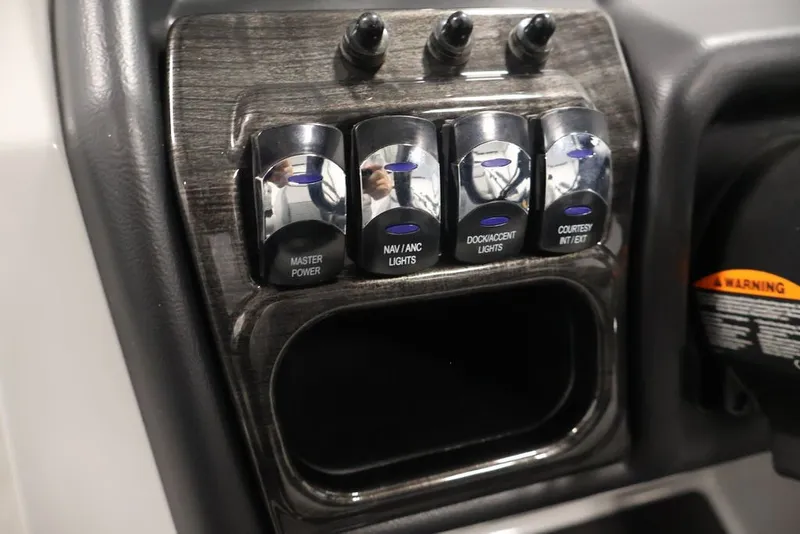 Slide: The Image of Control panel of 2026 Bentley Pontoons 223 ELITE SWINGBACK DUAL CAPTAIN with labeled switches. - 36