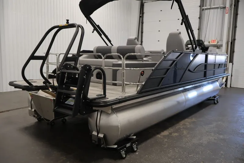 Slide: The Image of 2026 Bentley Pontoons 223 Elite Swingback Dual Captain in a showroom, showcasing sleek design. - 11