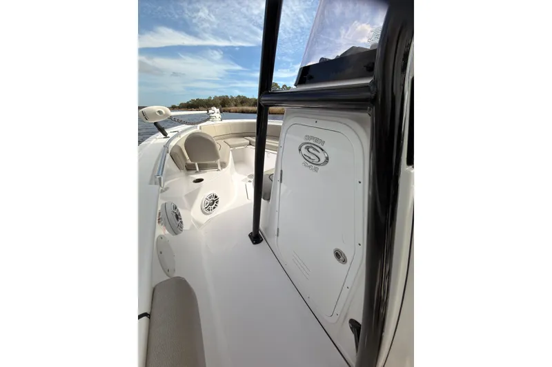 Slide: The Image of 2022 Sportsman Open 242 Center Console boat interior with seating and storage. - 10