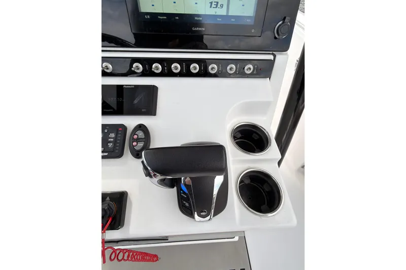 Slide: The Image of 2022 Sportsman Open 242 Center Console dashboard with controls and cup holders. - 14