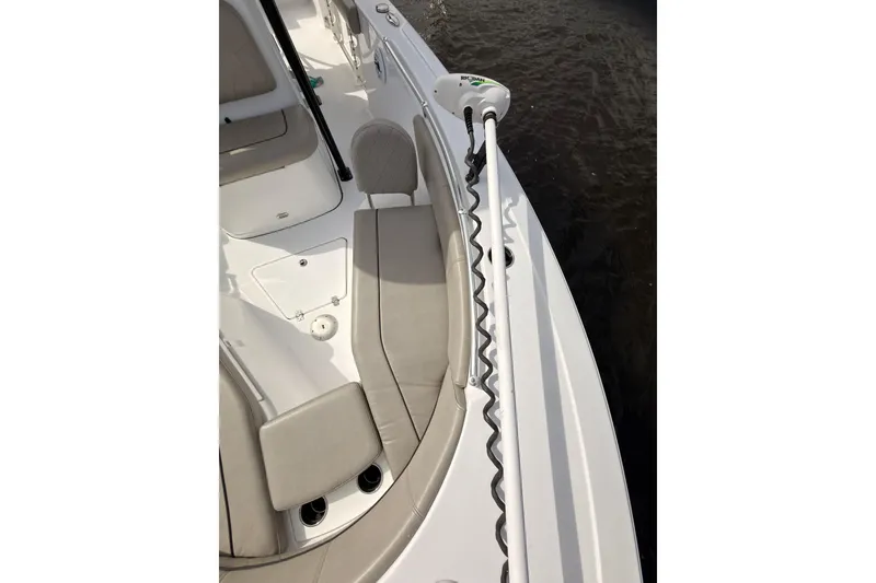 Slide: The Image of 2022 Sportsman Open 242 Center Console boat interior with seating and trolling motor. - 17