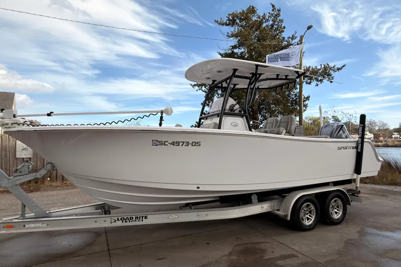 Slide: The Image of 2022 Sportsman Open 242 Center Console boat on trailer, parked outdoors. - 3