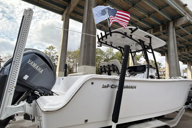 Slide: The Image of 2022 Sportsman Open 242 Center Console boat with Yamaha engine under a bridge. - 4