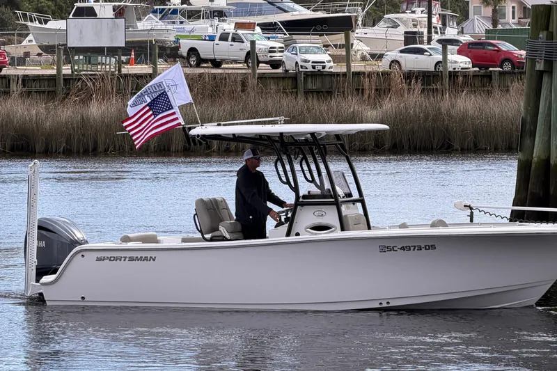 Slide: The Image of 2022 Sportsman Open 242 Center Console boat on water, American flag displayed. - 5