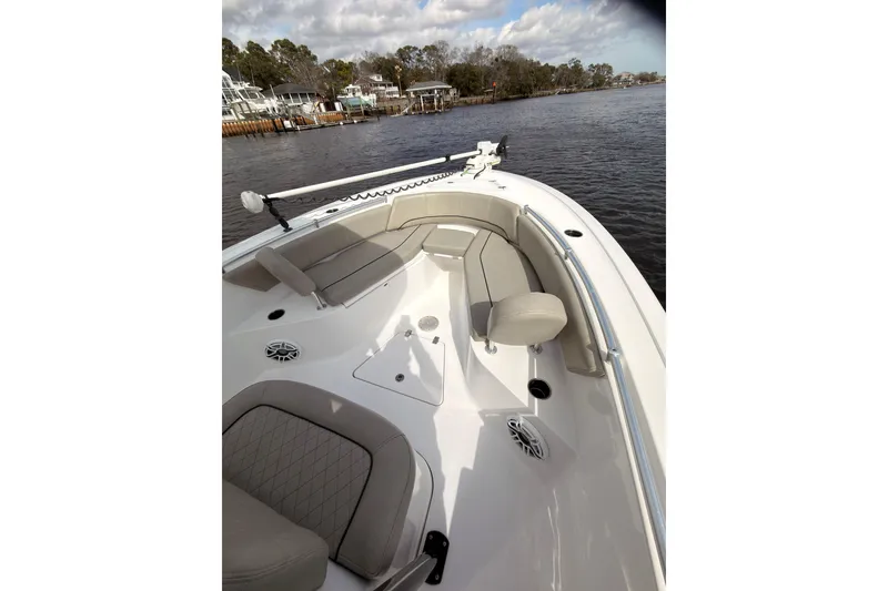 Slide: The Image of 2022 Sportsman Open 242 Center Console boat with spacious seating on a calm waterway. - 9