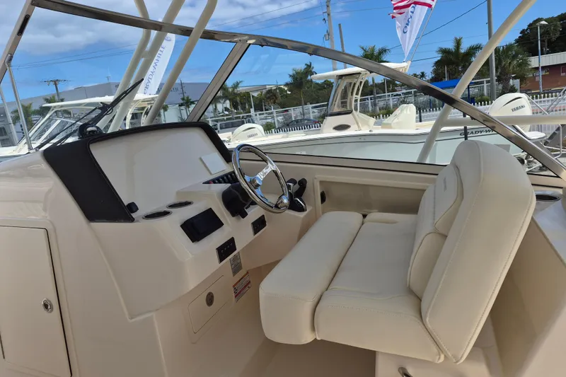 Slide: The Image of 2026 Grady-White Freedom 285 boat interior with steering wheel and seating. - 12