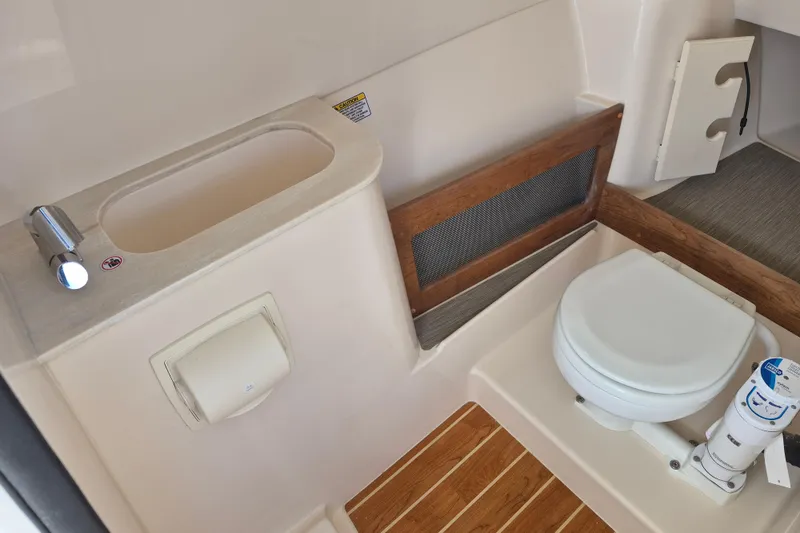 Slide: The Image of 2026 Grady-White Freedom 285 boat interior with compact bathroom amenities. - 17