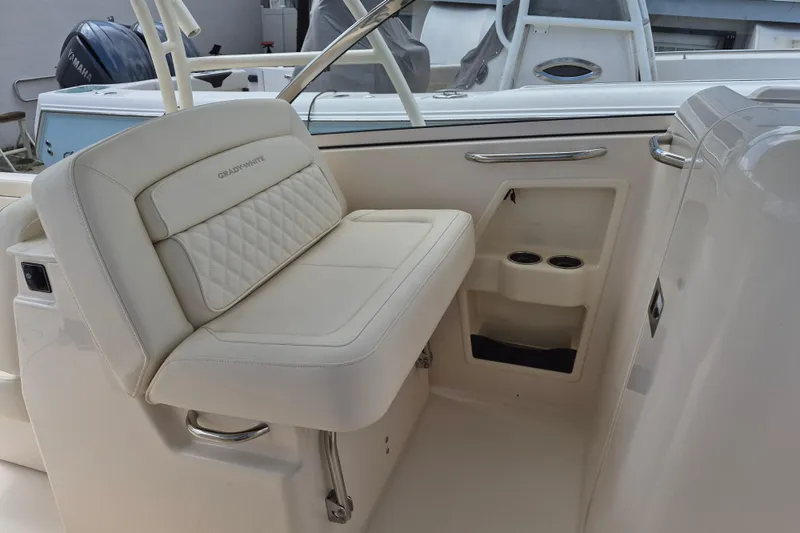 Slide: The Image of 2026 Grady-White Freedom 285 boat interior with cushioned seating and cup holders. - 19