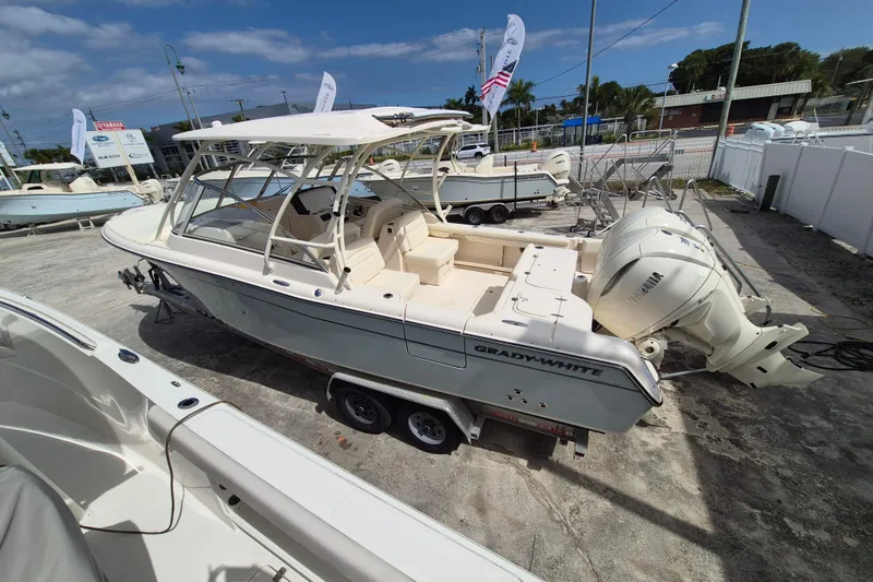Slide: The Image of 2026 Grady-White Freedom 285 boat on trailer, featuring dual Yamaha outboard engines. - 27