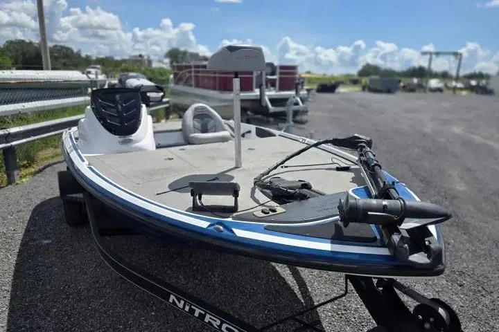 Slide: The Image of 2017 Nitro Z17 fishing boat on trailer, parked outdoors under a clear blue sky. - 10