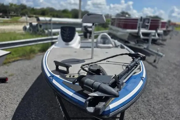 Slide: The Image of 2017 Nitro Z17 boat with trolling motor on gravel lot under blue sky. - 11