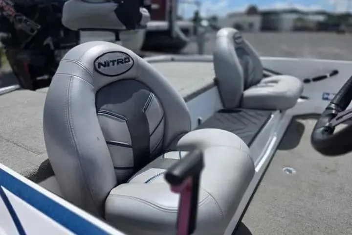 Slide: The Image of 2017 Nitro Z17 boat seats with gray upholstery and logo, parked outdoors. - 13