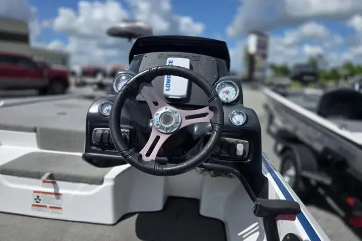 Slide: The Image of 2017 Nitro Z17 boat dashboard with steering wheel and gauges under a blue sky. - 16