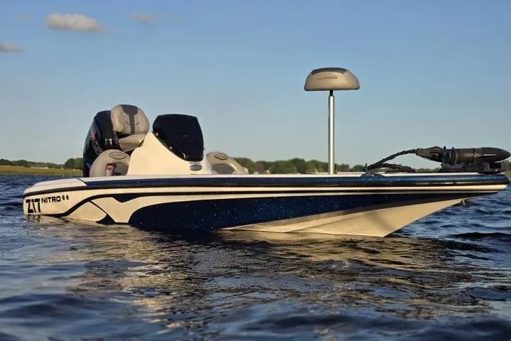 Slide: The Image of 2017 Nitro Z17 boat on calm water under clear sky. - 27