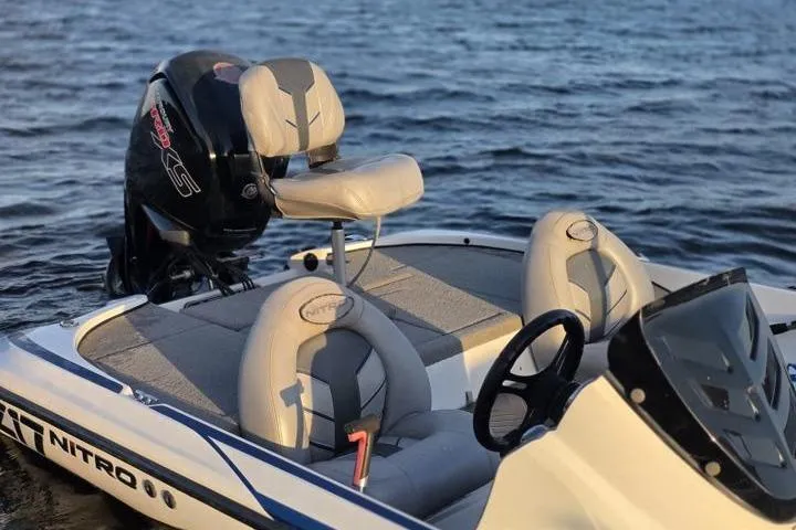 Slide: The Image of 2017 Nitro Z17 boat with cushioned seats and powerful outboard motor on water. - 35