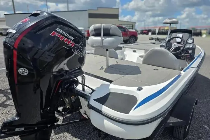 Slide: The Image of 2017 Nitro Z17 boat with Mercury Pro XS engine, parked outdoors under a cloudy sky. - 5