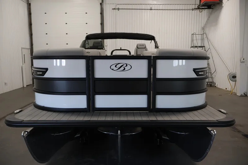 Slide: The Image of 2026 Bentley Pontoons 253 Swingback Dual Captain Elite Tri-Toon in a showroom setting. - 1