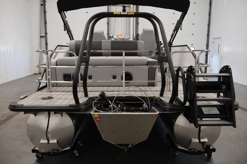 Slide: The Image of 2026 Bentley Pontoons 253 Swingback Dual Captain Elite Tri-Toon, rear view in a showroom. - 5