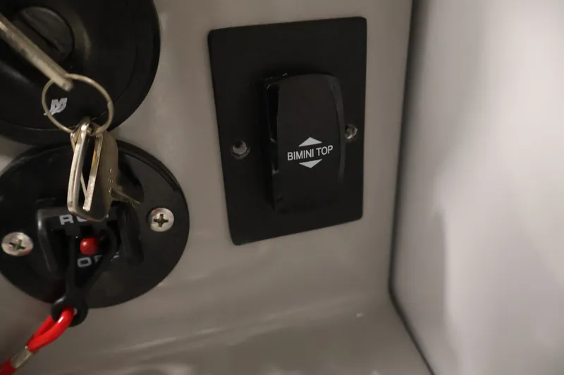 Slide: The Image of Bimini top switch and ignition keys on 2026 Bentley Pontoons 253 Swingback Dual Captain Elite Tri-Toon. - 28