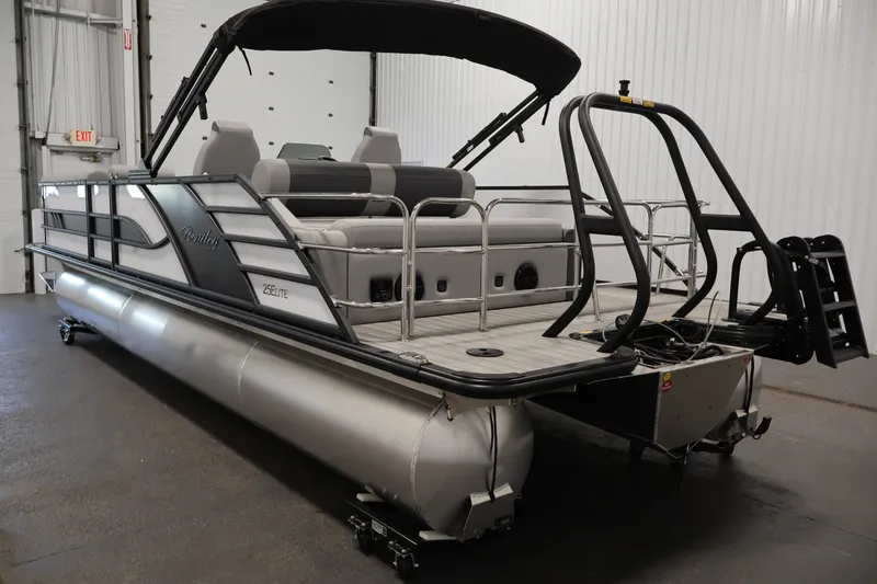 Slide: The Image of 2026 Bentley Pontoons 253 Swingback Dual Captain Elite Tri-Toon in a showroom setting. - 6