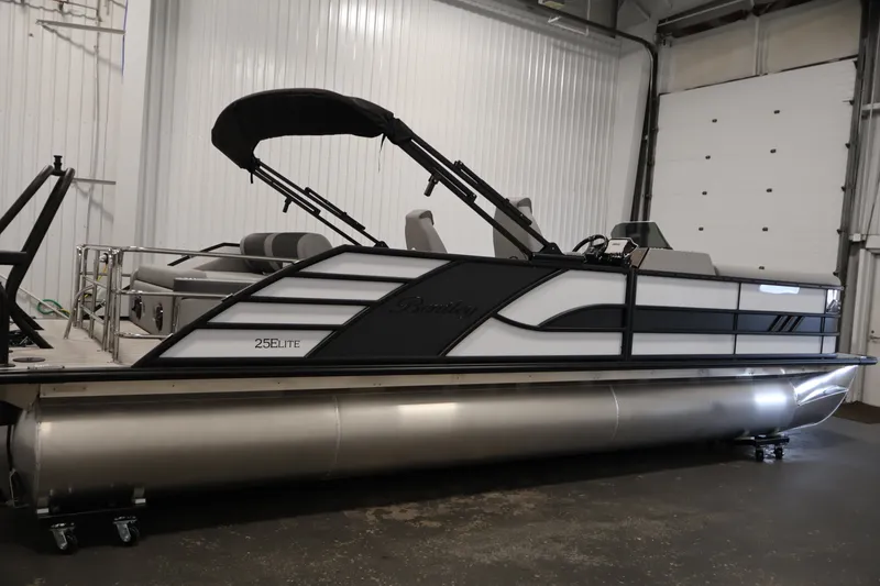 Slide: The Image of 2026 Bentley Pontoons 253 Swingback Dual Captain Elite Tri-Toon in a showroom setting. - 3