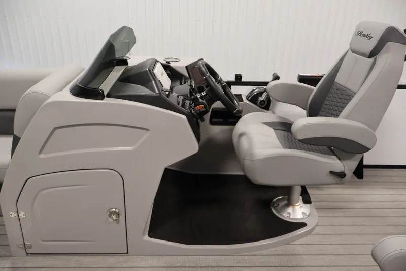 Slide: The Image of Interior of 2026 Bentley Pontoons 253 Swingback Dual Captain Elite Tri-Toon, featuring captain's chair and console. - 18
