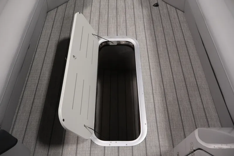 Slide: The Image of Open storage compartment on 2026 Bentley Pontoons 253 Swingback Dual Captain Elite Tri-Toon. - 17