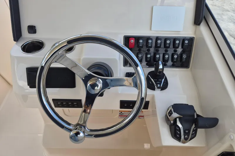 Slide: The Image of Steering console of 2026 Grady-White Freedom 285 boat with controls and switches. - 13