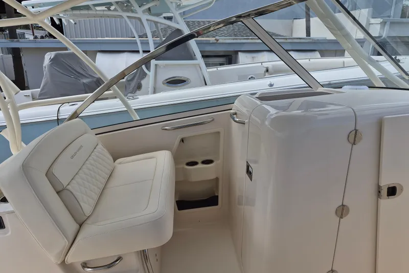Slide: The Image of 2026 Grady-White Freedom 285 boat interior with white seating and sleek design. - 17