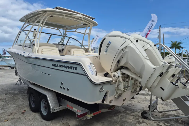 Slide: The Image of 2026 Grady-White Freedom 285 boat with Yamaha engines on a trailer, under blue sky. - 23