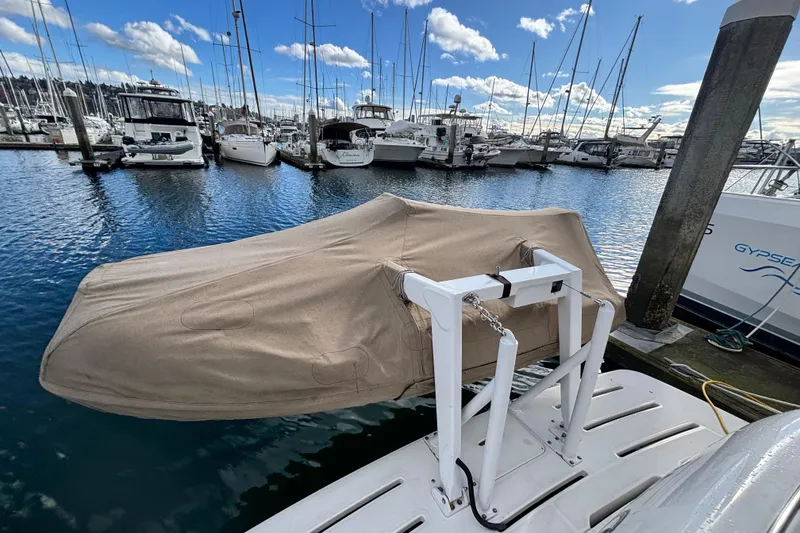 Slide: The Image of Covered boat on a dock, surrounded by yachts, under a blue sky. Meridian 411 Sedan, 2004. - 101