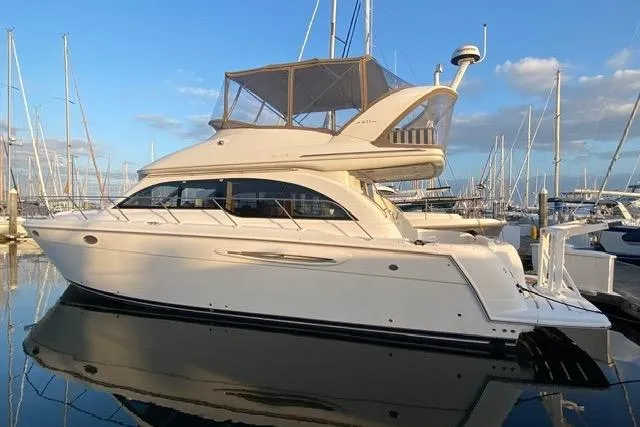 Slide: The Image of 2004 Meridian 411 Sedan yacht docked at marina, reflecting on calm water. - 107