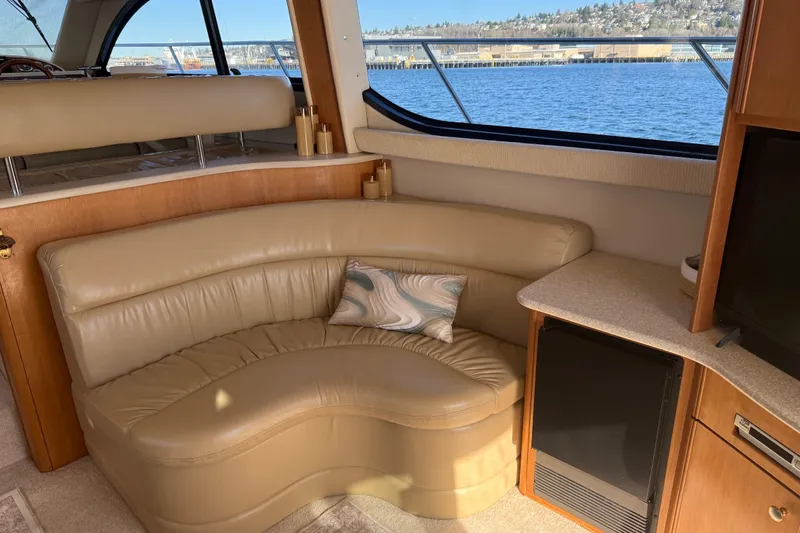 Slide: The Image of Luxurious interior of 2004 Meridian 411 Sedan yacht with leather seating and scenic window view. - 13