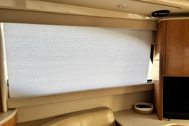 Slide: The Image of Interior of a 2004 Meridian 411 Sedan with window shade and wooden cabinetry. - 14