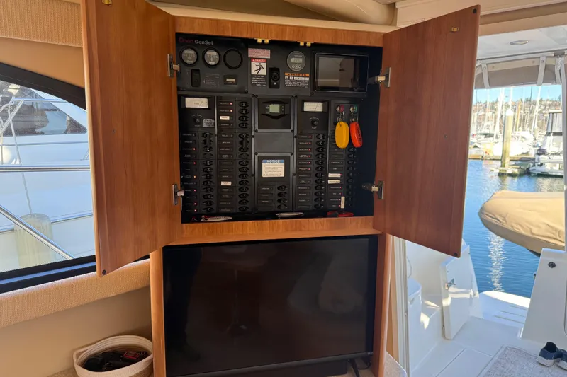 Slide: The Image of Electrical panel inside a 2004 Meridian 411 Sedan yacht, with marina view. - 16
