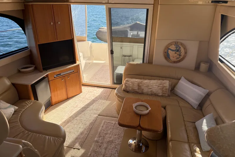 Slide: The Image of Luxurious interior of 2004 Meridian 411 Sedan yacht with cozy seating and ocean view. - 17