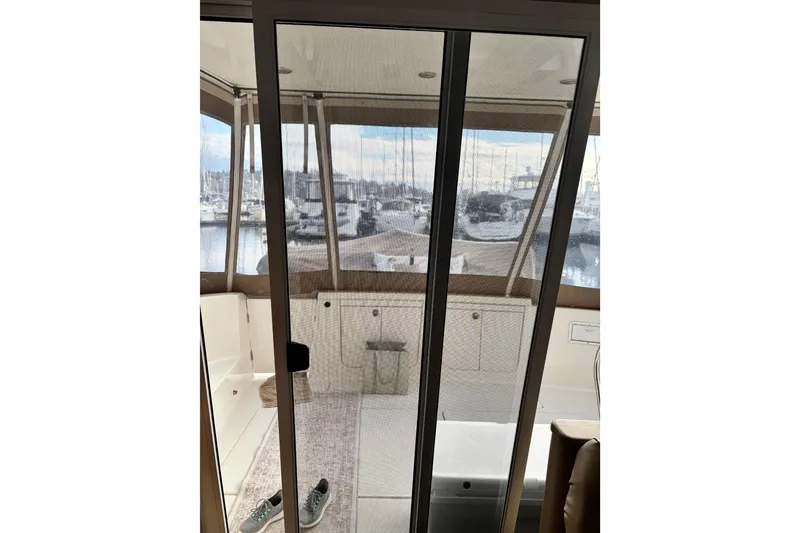 Slide: The Image of Interior view of 2004 Meridian 411 Sedan yacht with marina backdrop. - 18