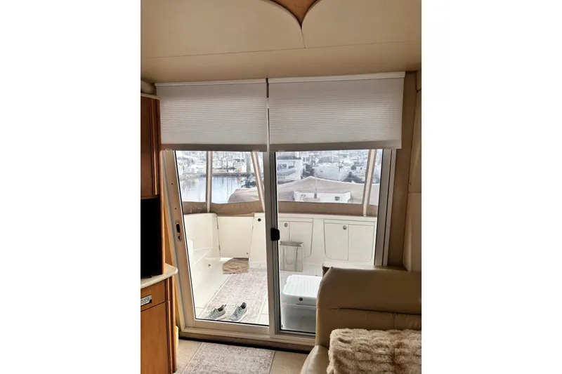 Slide: The Image of Interior view of 2004 Meridian 411 Sedan yacht with sliding glass door and marina view. - 19