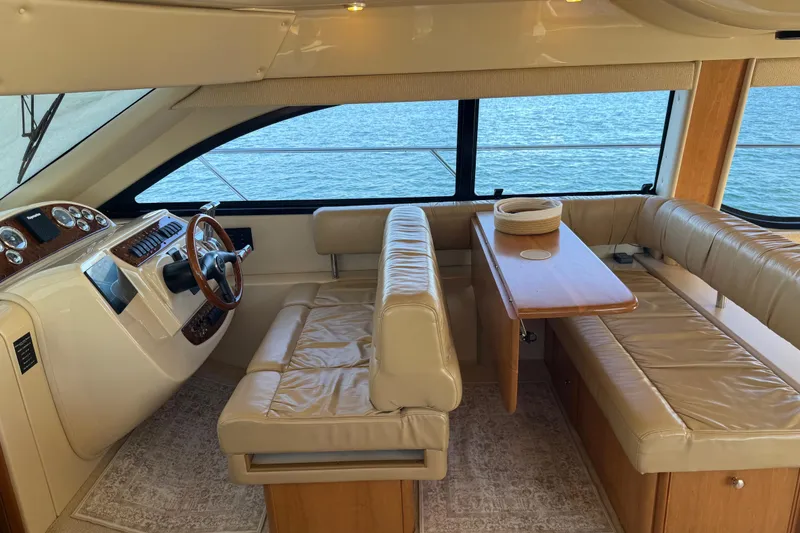 Slide: The Image of Luxurious interior of a 2004 Meridian 411 Sedan yacht with leather seating and wooden accents. - 27