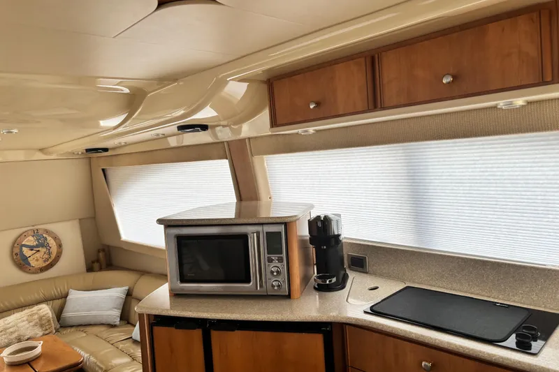 Slide: The Image of Interior of 2004 Meridian 411 Sedan yacht with kitchen and seating area. - 34